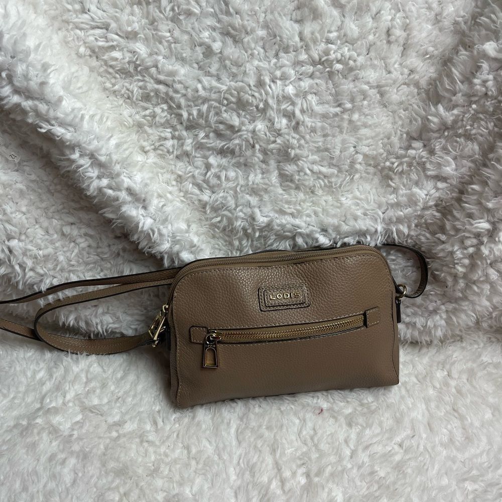 Lodis leather tan crossbody bag with gold tone hardwares adjustable strap.